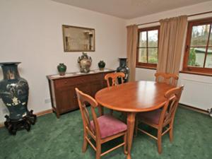 a dining room with a wooden table and chairs at The Wheelhouse in Linlithgow