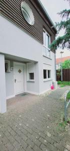 a white house with a garage with a frisbee at Köpenick 43 mit WLAN in Berlin
