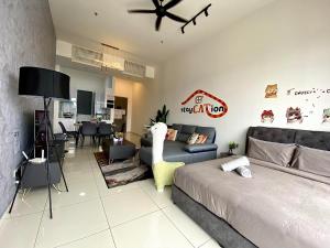 a bedroom with a bed and a living room at Beacon Executive Suite by stayCATion Homestay in George Town