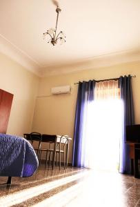 シラクーサにあるCasa Teresa Siracusaのベッドルーム1室(ベッド1台、テーブル、窓付)