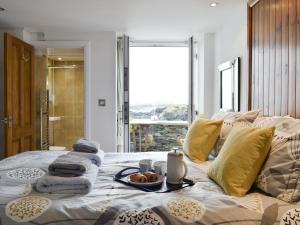 a bed with a tray of food on top of it at Old Brewery Cottage - S4576 in Ellanbeich