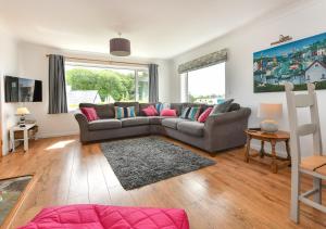 a living room with a couch and a table at Llys Neigwl in Abersoch
