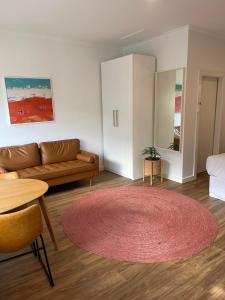 a living room with a couch and a table at Harbour View Motel in Robe