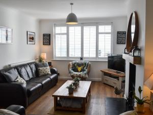 a living room with a couch and a coffee table at Craster View in Craster