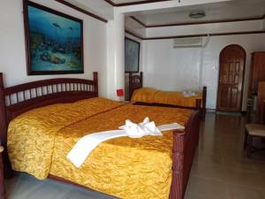 Tempat tidur dalam kamar di Lalaguna Beach Club & Dive Centre