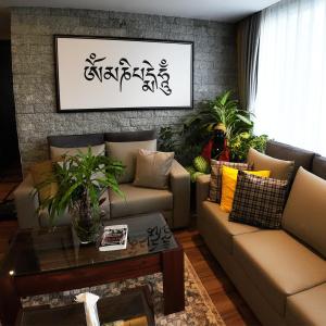 a living room with two couches and a table at LASA HOMES in Gangtok
