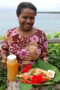 una mujer sosteniendo un plato de comida con un plato de comida en Nawori Sea View Bungalows N tours Packages, en Wortatcha