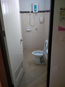 a bathroom with a toilet and a shower at เดอะกรีนฟอเรสท์ รีสอร์ท in Hat Yai