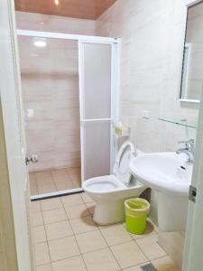 a bathroom with a toilet and a sink at Yellow Bell in Guiren