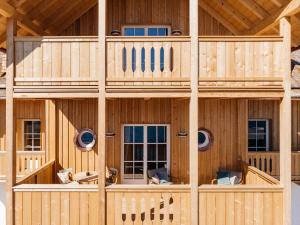 uma grande casa de madeira com uma varanda em Villa Alma - a lakeside Boutique Hotel em Sankt Gilgen