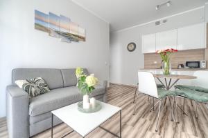 - un salon avec un canapé et une table dans l'établissement Apartament Doris 2 - 50 m do plaży, à Pobierowo