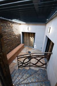 a room with a staircase and a brick wall at CARACALLA PRIVE - Chambres d'hôtes avec Piscine, Jaccuzi et Hammam privatifs in Saint-Étienne