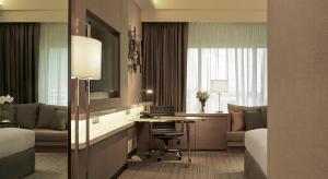 a hotel room with a bed and a desk in it at JW Marriott Kuala Lumpur - TravelEase Visa-Free Getaway in Kuala Lumpur