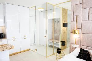 a bedroom with a glass shower and a bed at Penthouse apartments MINI s privátnou vírivou vaňou in Trstená +14 photos