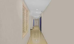 a hallway in a building with a long corridor at FabHotel Luck Inn Residency in Chennai