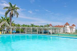 a large swimming pool in front of a resort at Hospitality Expert F36 Beach front Pool & Chef in Montego Bay