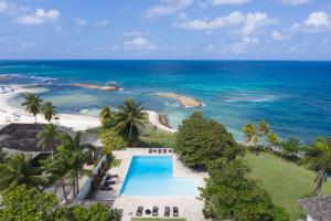 an aerial view of a resort with a swimming pool and the ocean at Hospitality Expert F36 Beach front Pool & Chef in Montego Bay