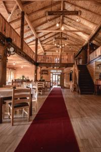 a large room with a red carpet in a barn at JELA NATURAL RESORT in Rožaje