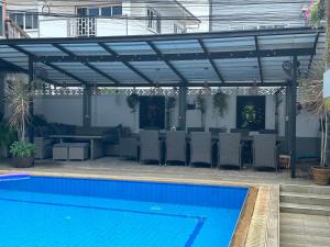 a patio with a swimming pool and a pergola at Friends of Koh Samui 1 in Ban Lamai