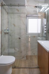 een badkamer met een douche, een toilet en een wastafel bij EDEL Suite in Chania