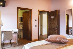 a bedroom with a bed and two open doors at Masseria del Bosco - Podere Poderuccio in Chianciano Terme