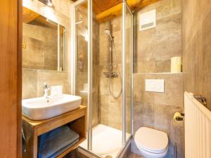 a bathroom with a shower and a sink and a toilet at beautifully renovated farmhouse Stoanerbauer with a wonderful view in Dorf