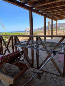 a glass table in a building with a view of the desert at Sea View apartment in Dahab