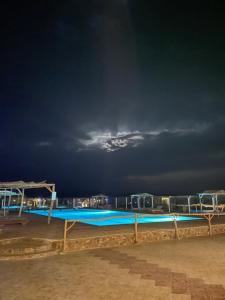 a view of a swimming pool at night at Sea View apartment in Dahab
