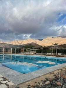 a large swimming pool with mountains in the background at Sea View apartment in Dahab