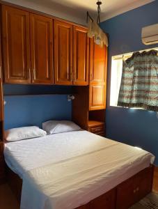 a bedroom with a bed and wooden cabinets at Sea View apartment in Dahab