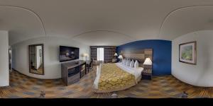 a hotel room with a bed and a flat screen tv at Baymont by Wyndham - Chicago - Addison - O'Hare in Addison