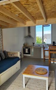 a living room with a couch and a table at Studio Gypsy in Isigny-le-Buat