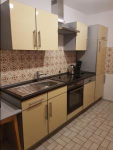 a kitchen with white cabinets and a sink at Haus Irmgard in Zell am Harmersbach