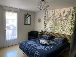 a bedroom with a bed with a blue comforter at UNE AGREABLE CHAMBRE INDEPENDANTE in Rilhac-Rancon +17 photos