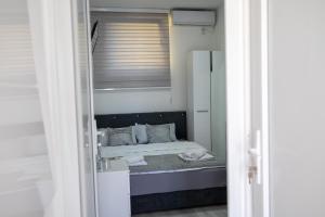 a bedroom with a bed with a mirror at Felicita Apartments Brcko in Brčko