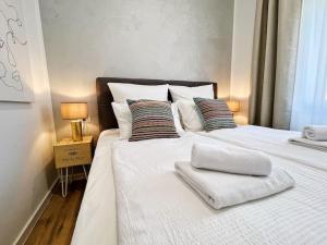 a large white bed with two pillows on it at Chariming and Comfy Studio in Pula