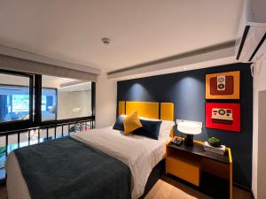 a bedroom with a king sized bed and a balcony at Livetour Hotel HaiZhu Hopson New Plaza Guangzhou in Guangzhou