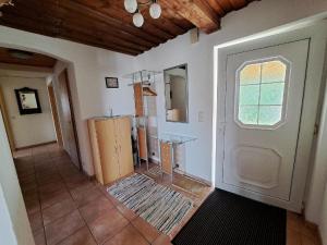 a room with a white door and a window at Bauernhof Madlhof in Neuschönau