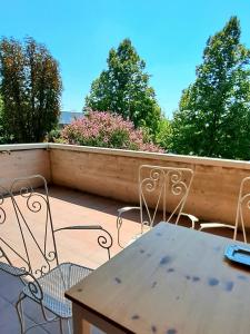 a table and chairs on a balcony with trees at 26 Bed and Breakfast in Casinalbo