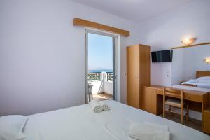 A bed or beds in a room at Lambis Studios & Apartments