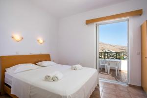 A bed or beds in a room at Lambis Studios & Apartments