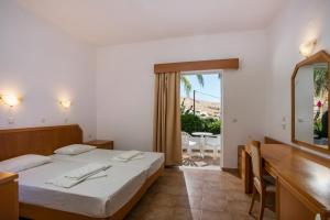 A bed or beds in a room at Lambis Studios & Apartments