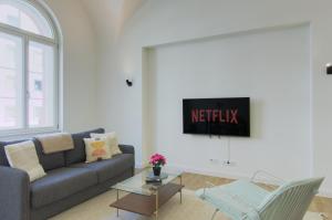 a living room with a couch and a table at vonBehling Boutique Apt. - Historisch und modern in Wiesbaden