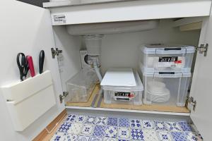 a kitchen with a sink and a kitchen floor at JH Yellow Guest House in Tokyo