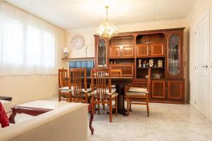 a dining room with a table and chairs and a clock at GuestReady - Vintage Elegance in Catalonia in Cornellà de Llobregat