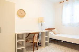 a bedroom with a desk and a bed at GuestReady - Vintage Elegance in Catalonia in Cornellà de Llobregat