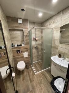 a bathroom with a shower and a toilet and a sink at Luxury Flat-4 People-Mladost in Varna City