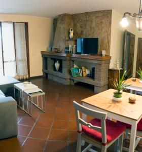 a living room with a table and a fireplace at 26 Bed and Breakfast in Casinalbo