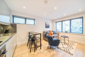 a living room with a couch and a table at Watt a Stay I Free EV Parking in Windsor