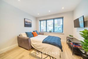 a bedroom with a bed and a window at Watt a Stay I Free EV Parking in Windsor +2 photos